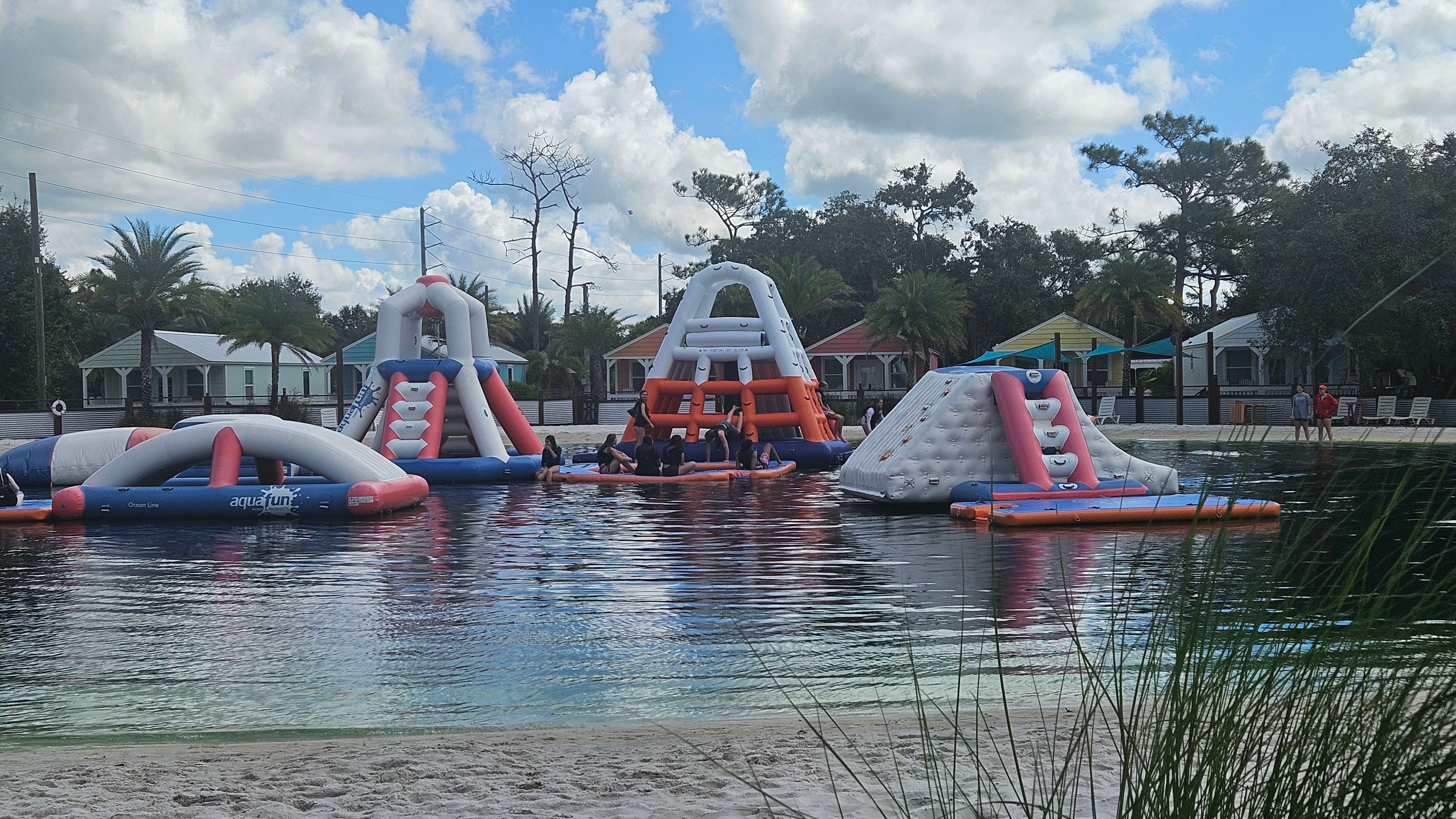 Children kayaking on a lake at camp, enjoying adventures under the sun.