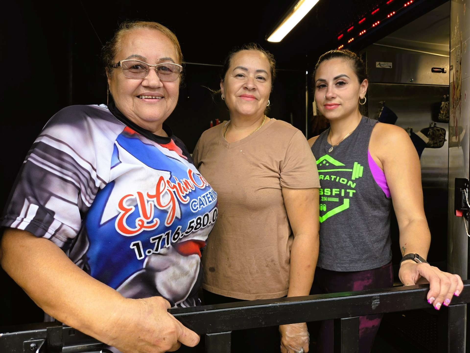 Three generations of the family behind El Gran Coqui Catering inside their Puerto Rican food trailer