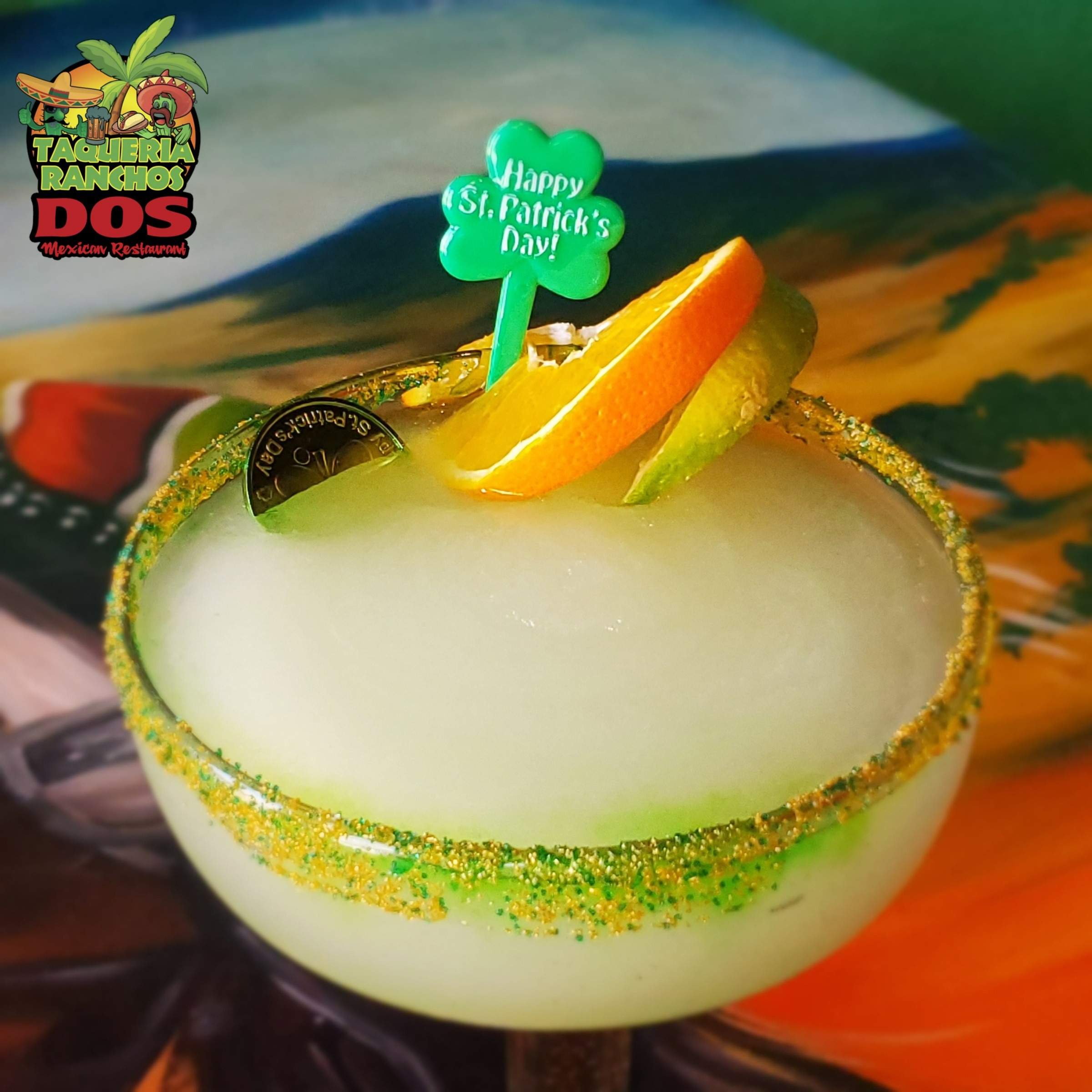 lime margarita with gold and green sugar on rim