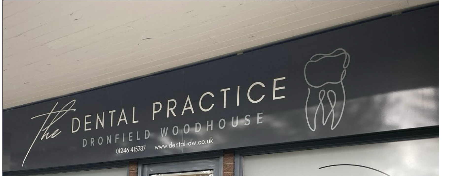 Clean dental clinic storefront with professional signs for cosmetic dental treatments.