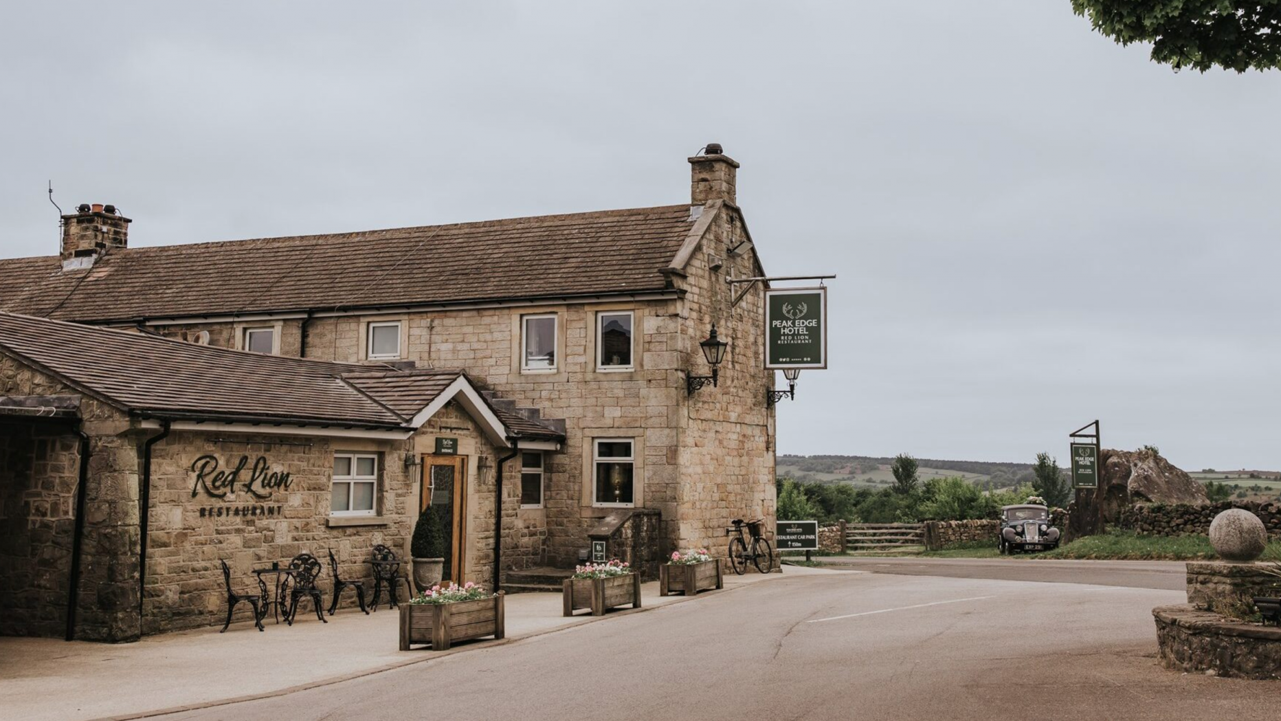 Red Lion Restaurant Chesterfield red-brick exterior in lush Peak District countryside