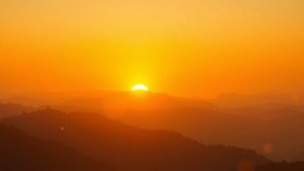 Golden sunrise over misty mountains during morning meditation.