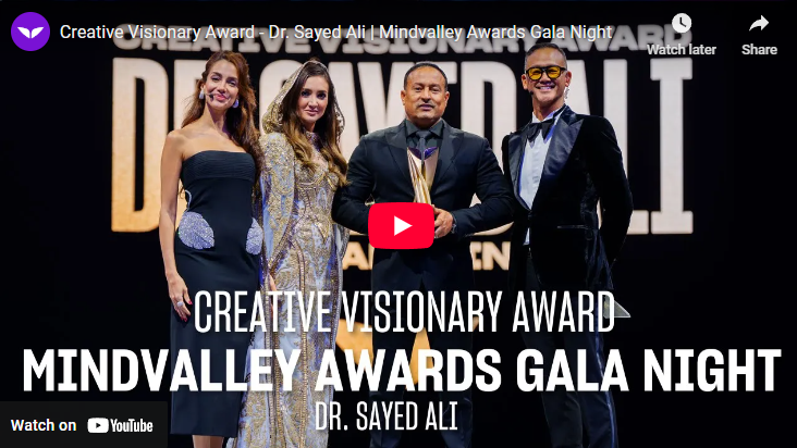 Creative Visionary Award ceremony with diverse group holding trophy.