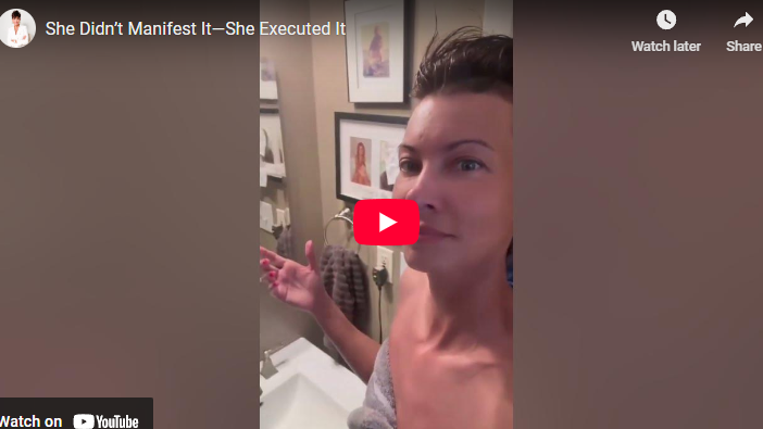 Person smiling in a bathroom with framed art, executing your dreams theme.