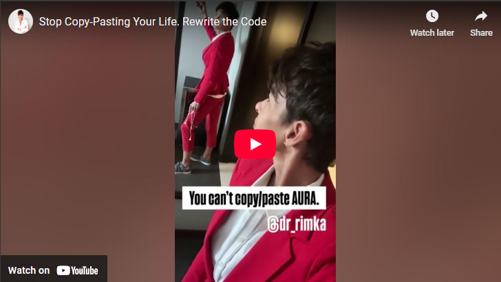 Rewrite Your Life Code: Stylish person in red suit looking in mirror.