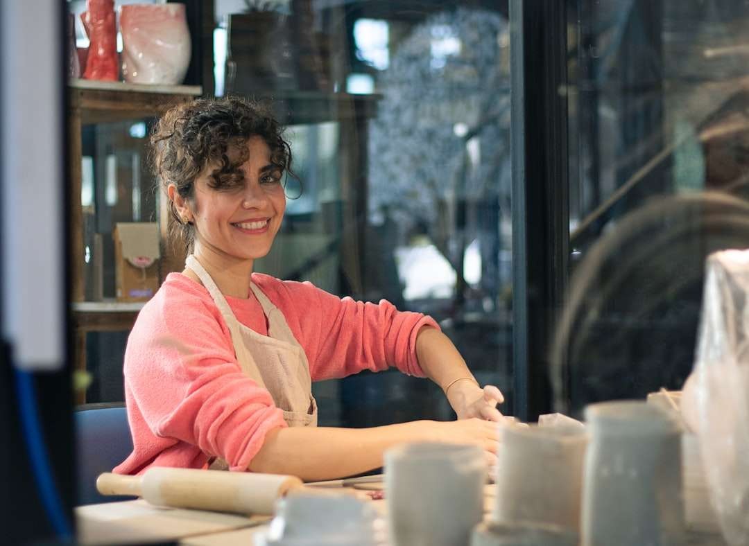 Middle-aged female bakery owner in soft blues, showcasing realism and detail.