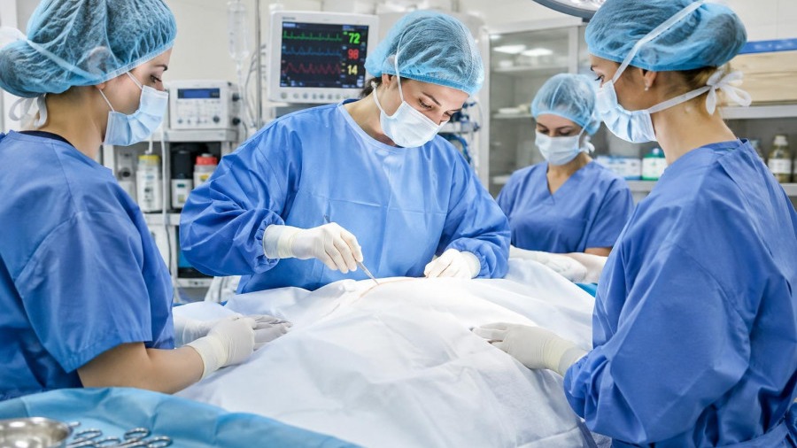 Surgery team performing penile enhancement safety procedures in a well-lit operating room.