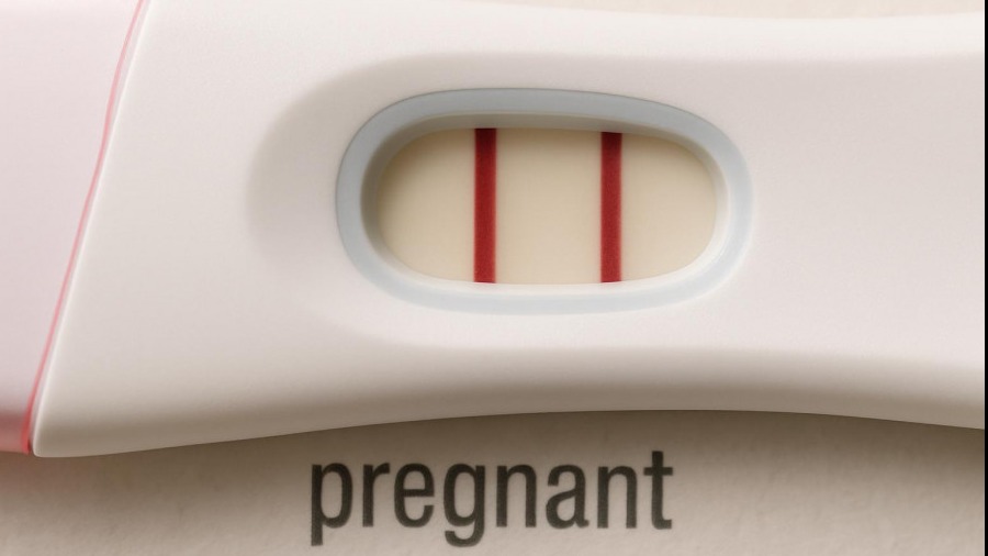Positive pregnancy test highlighting women's health and community wellness.