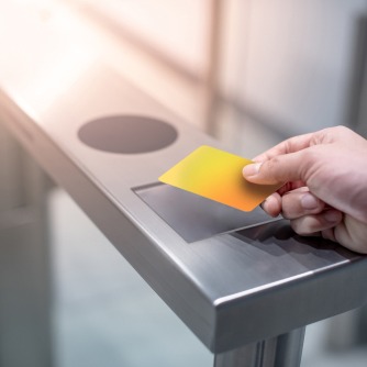 An employee using a pass to unlock access to the building through a smart access control system