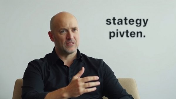 Bald man discusses restaurant chain strategy reset against light background with text.
