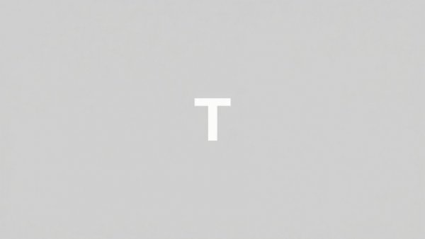 Plain grey image with a centered white 'T'.