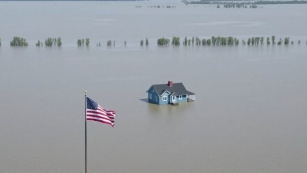 Climate change impact: Flooded house in Illinois with flags, aerial view.