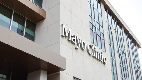 Mayo Clinic building with logo, modern architecture.