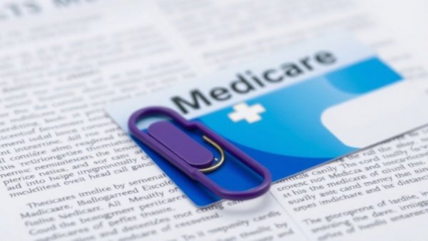 Medicare AI prior authorization: close-up card with paperclip.
