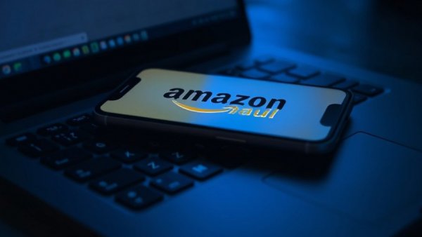 Amazon Haul logo on glowing phone over keyboard for expansion deals.