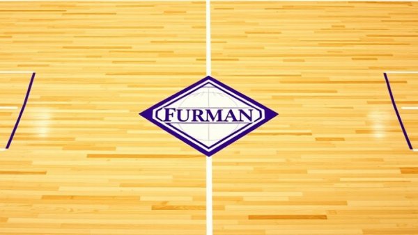 Furman University logo on basketball court, symbolizing a road win.