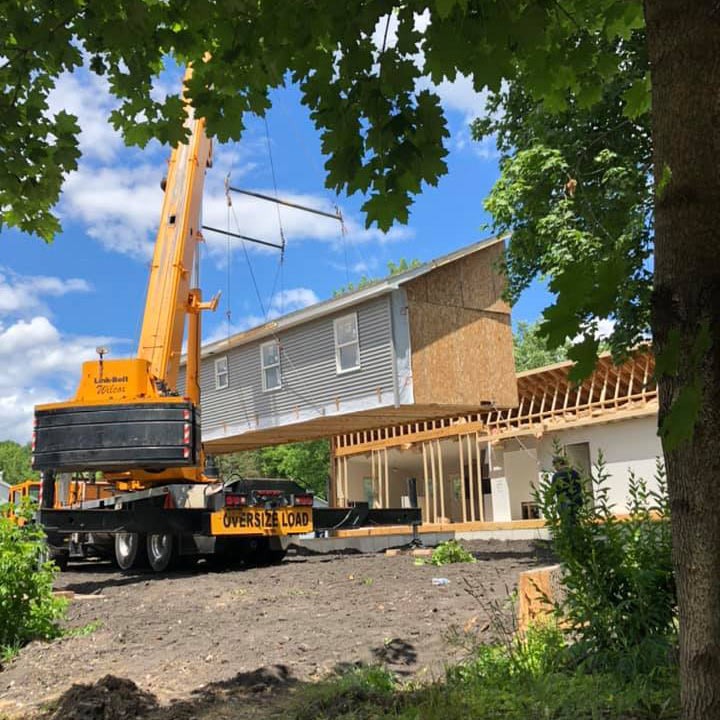powerful craneservices lift, determined expression, raising a massive load, photorealistic, industrial harbor with cargo ships in background, highly detailed, dynamic cables tensioned, fine grain, rusty red and steel, evening light, shot with an 85mm lens.