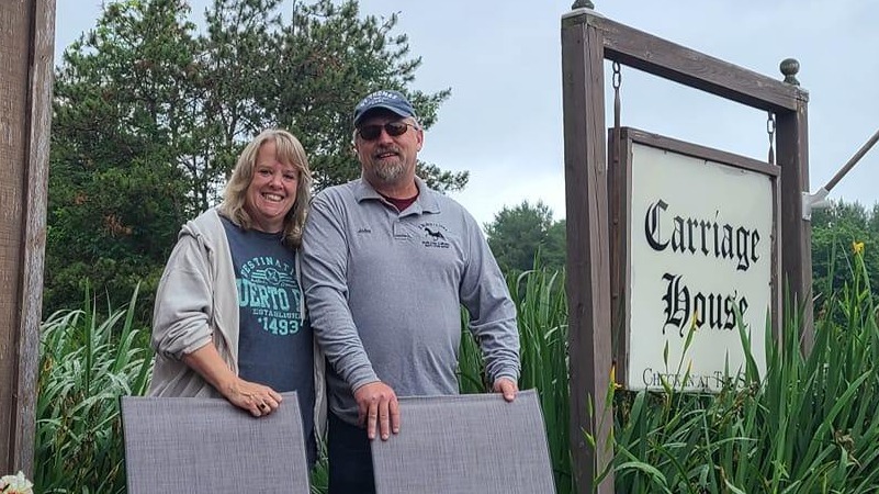 comfortable home escape, content, watching rain through a window, photorealistic, snug corner with fluffy blankets and cushions, highly detailed, raindrops trickling down the glass, high resolution, muted greens and blues, overcast lighting, shot with a 24mm lens.