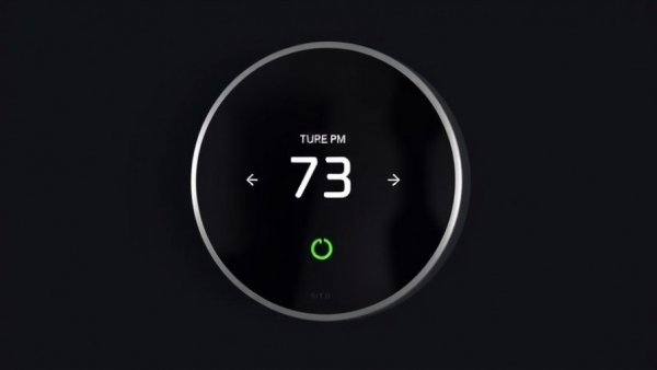 Modern smart thermostat displaying 73 degrees in black background.