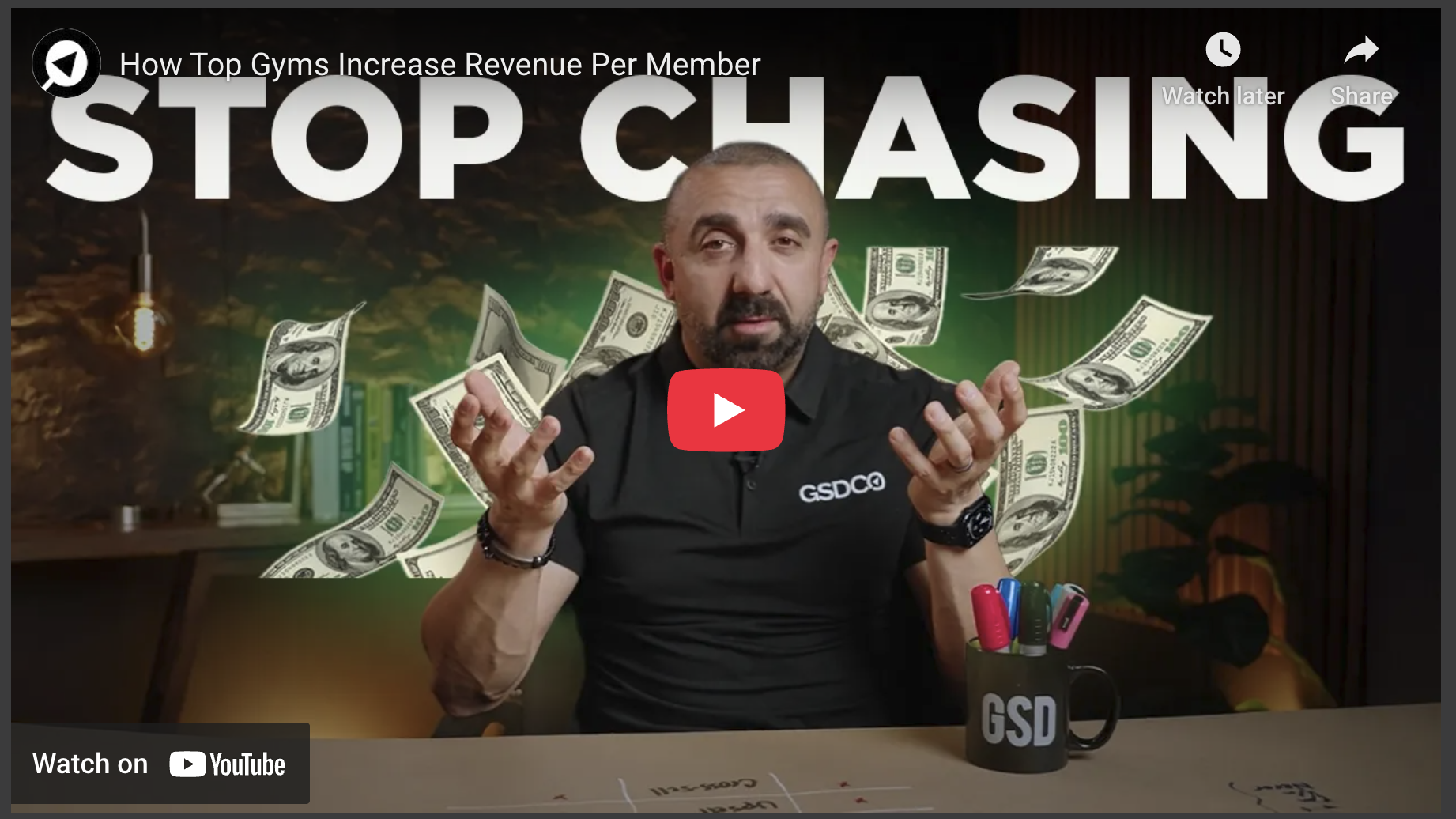 Man in office with floating dollar bills and motivational text.