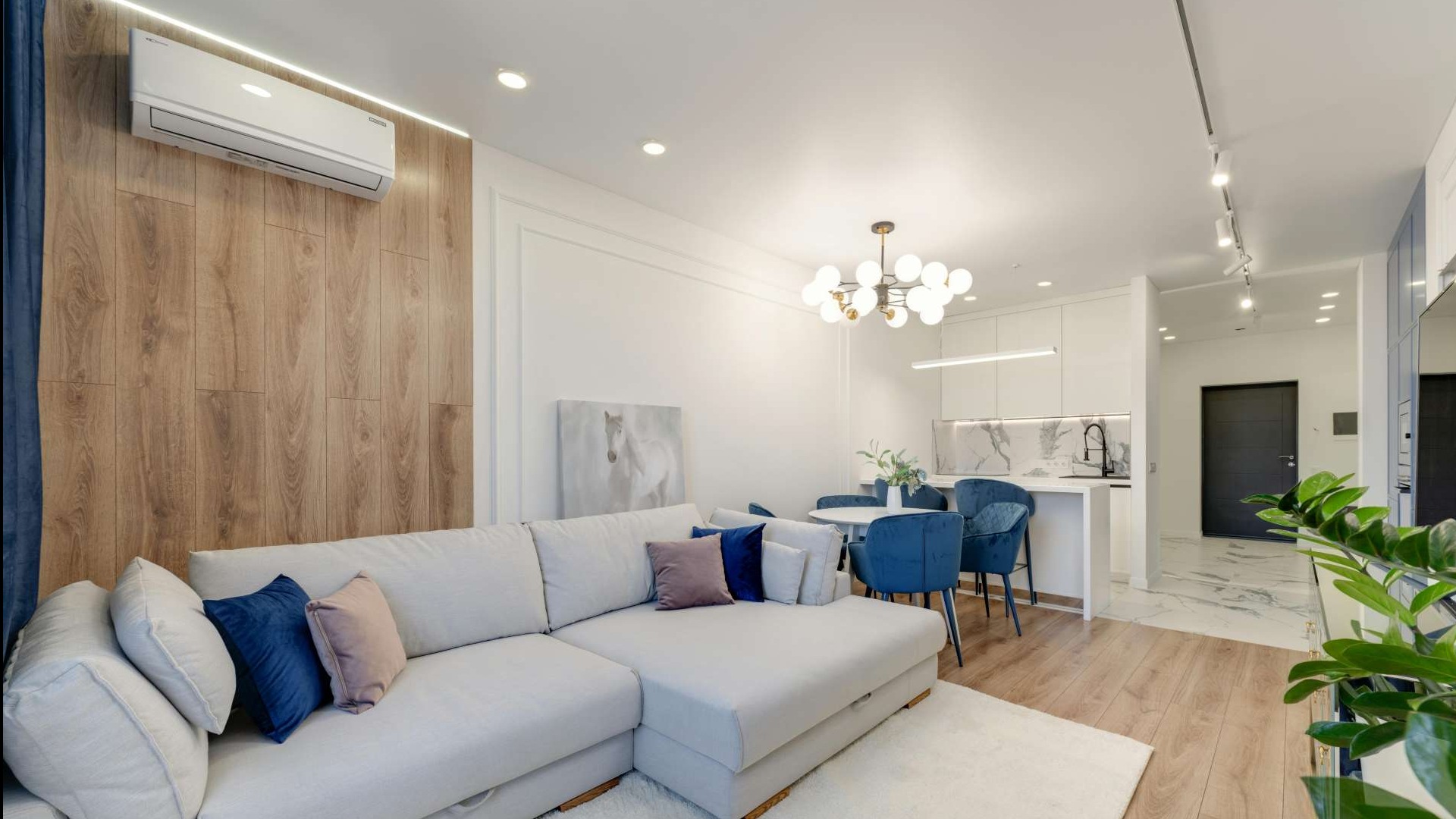 Person checking radiator in a tiled room, concept of HVAC impact on energy costs.