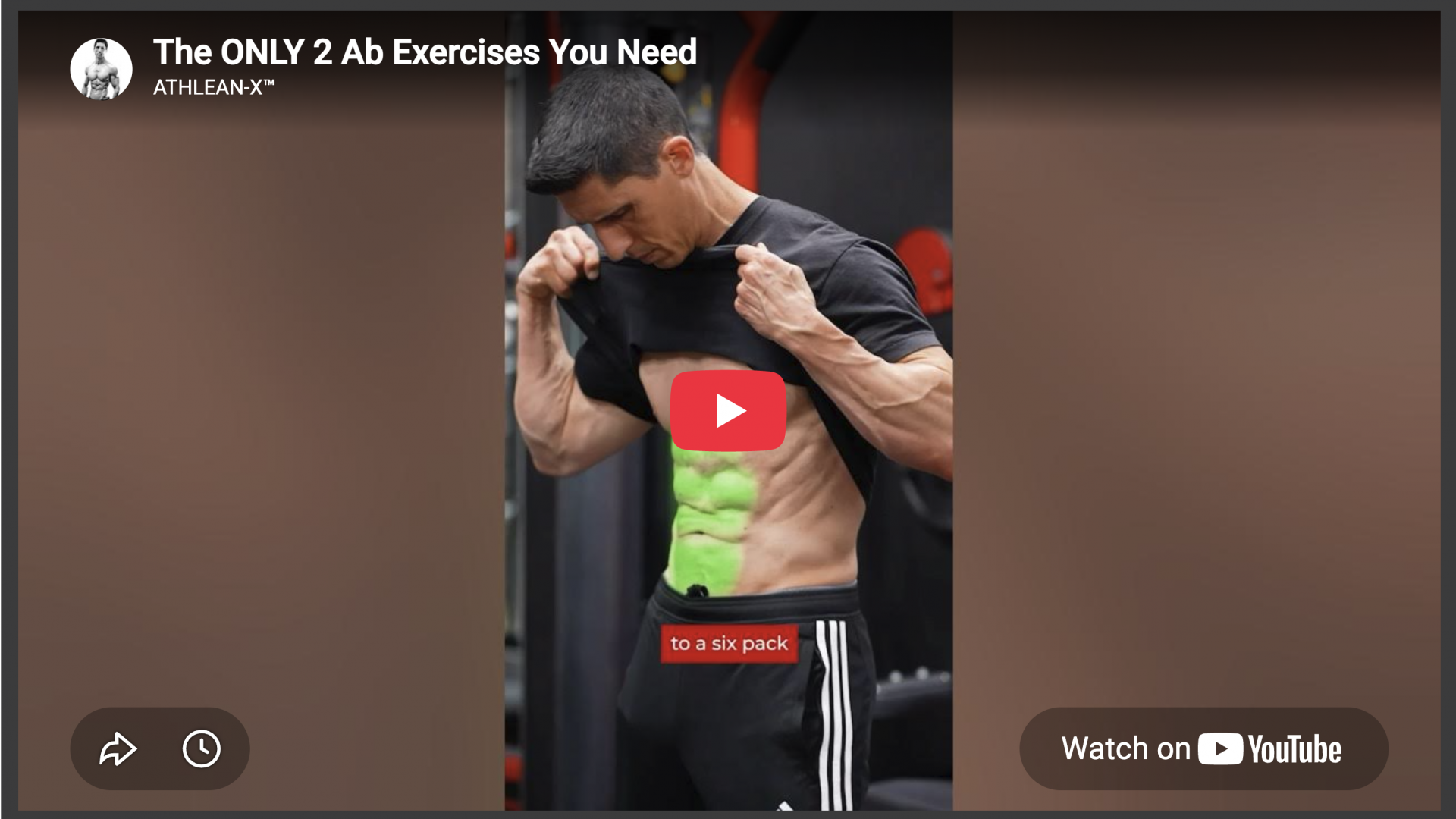 Muscular man showing defined abs in a gym setting.