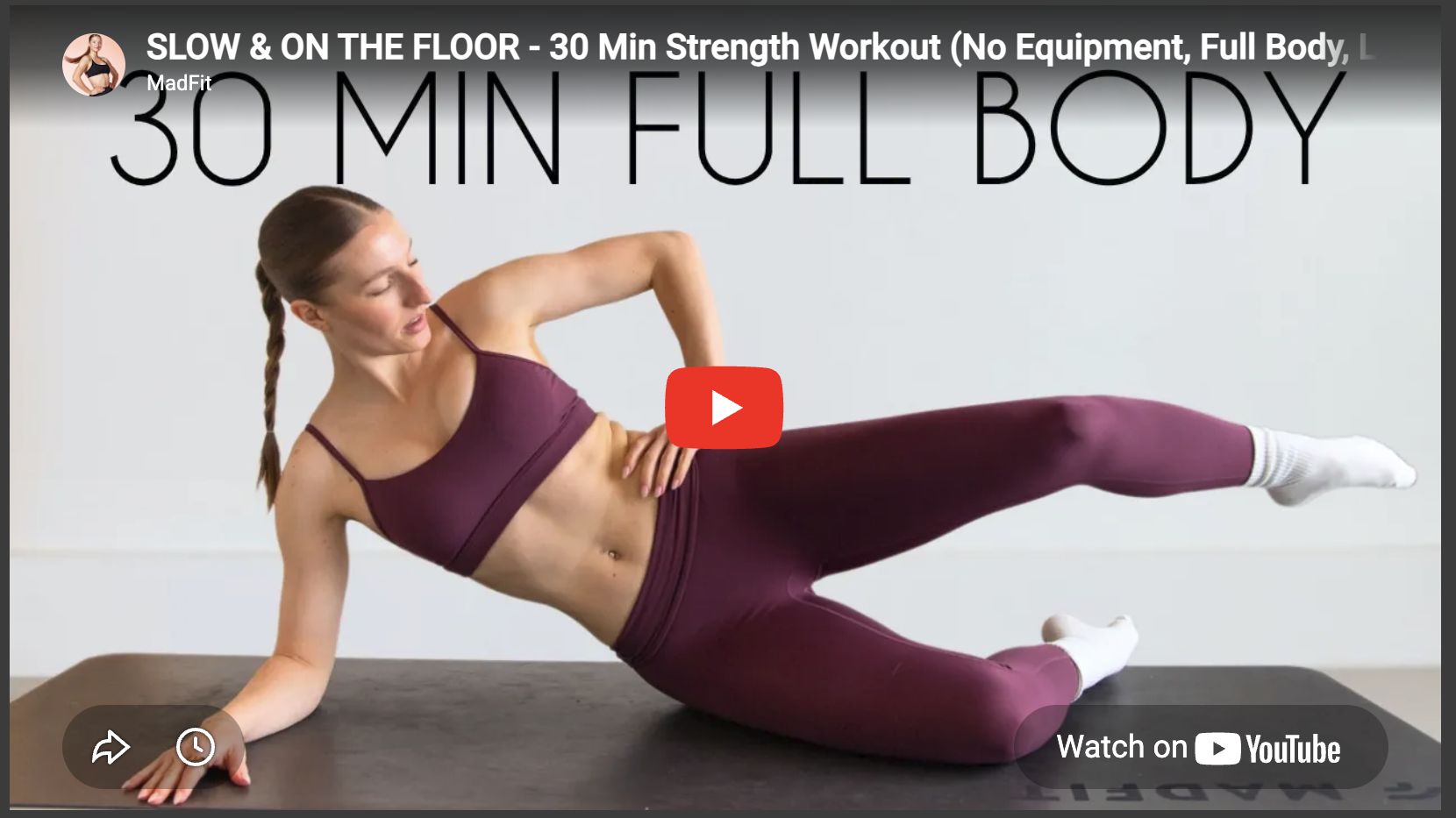 Athletic woman performing side plank in full body strength workout.