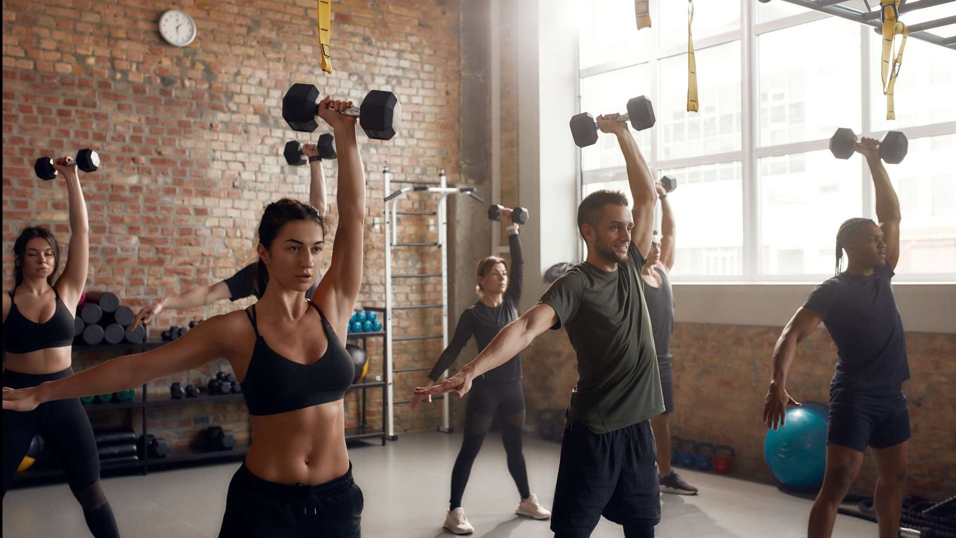 Athletic person lifting dumbbells, showcasing determination in a home workout guide.