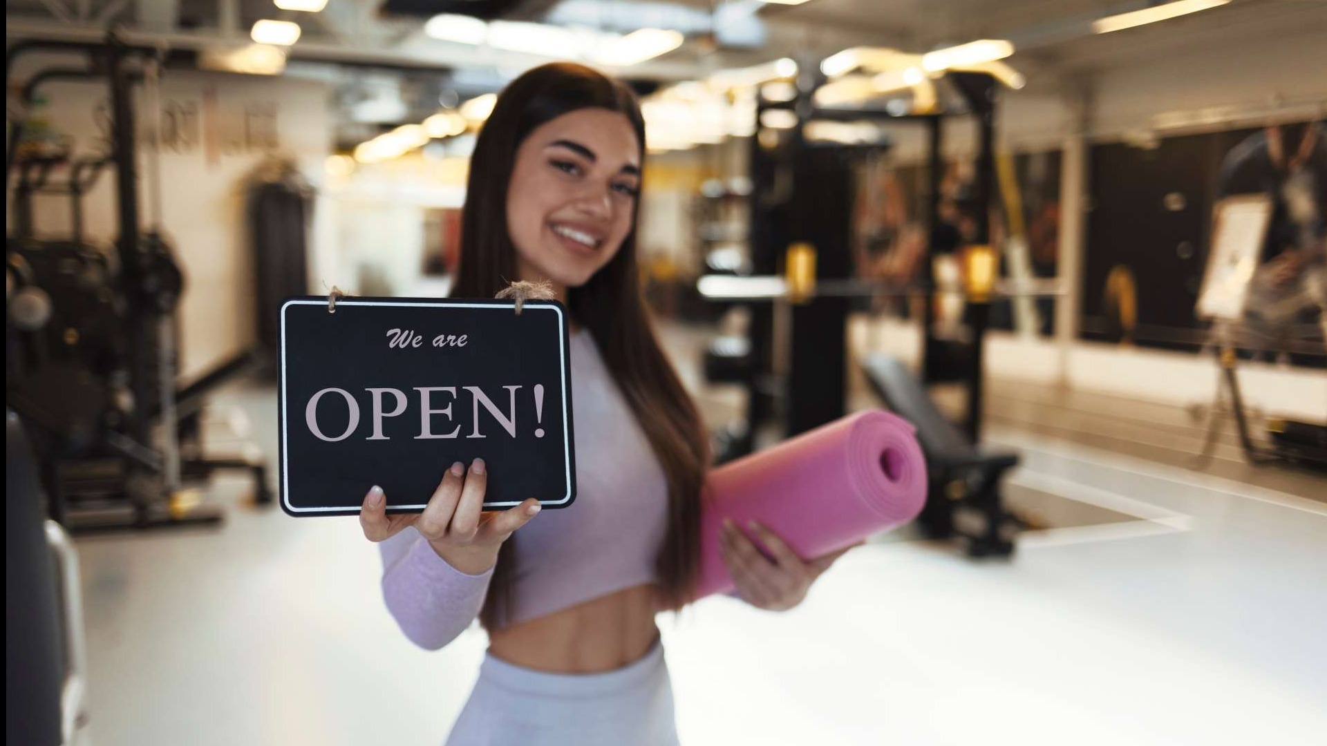 Happy workouts: Woman joyfully exercising in home gym.