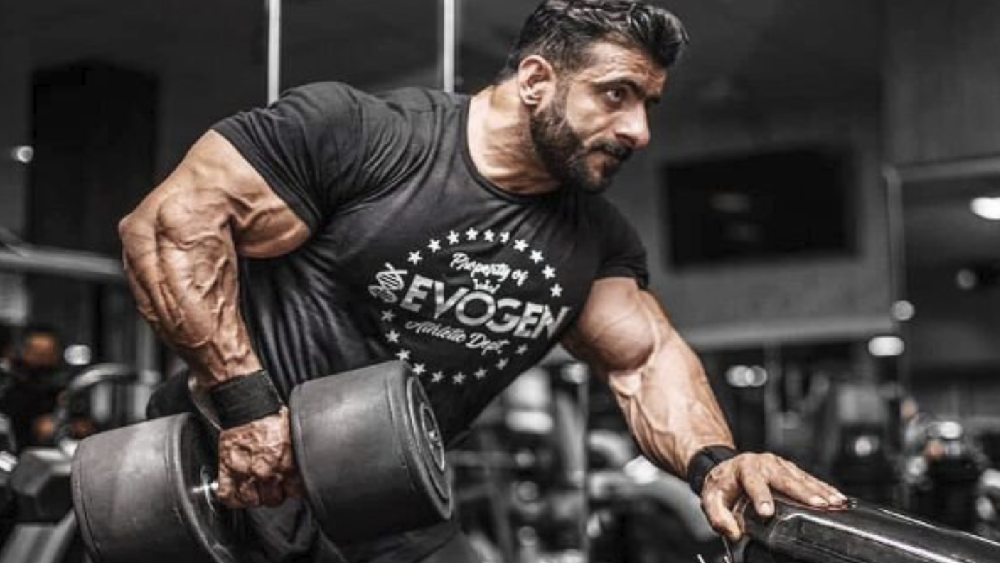 Determined bodybuilder Milos Sarcev backstage, embodying the fitness community spirit.
