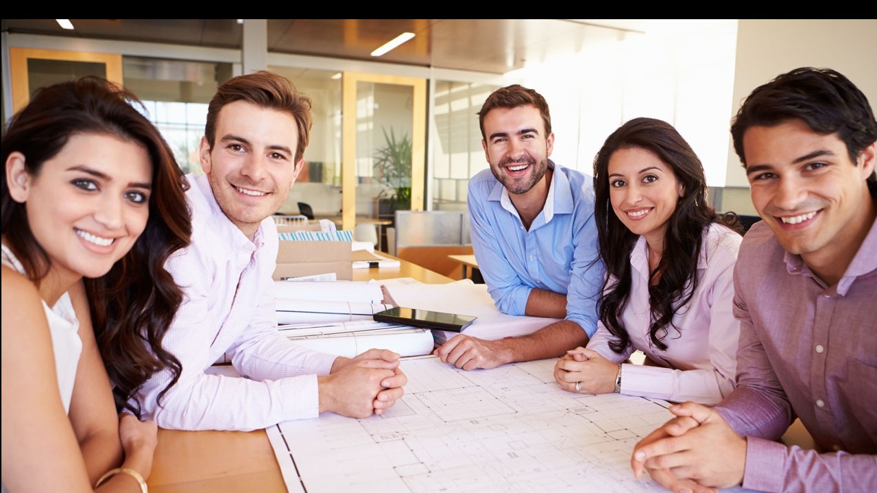 young professionals at table smiling