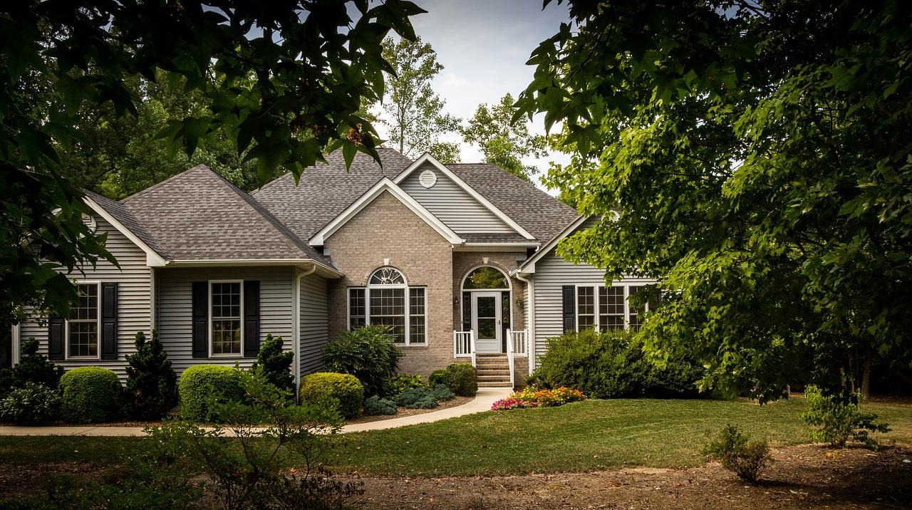 front of nice home with greenery