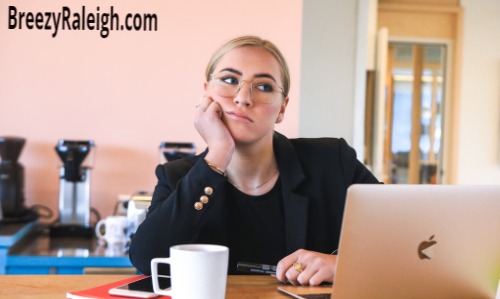 blonde female at computer thinking