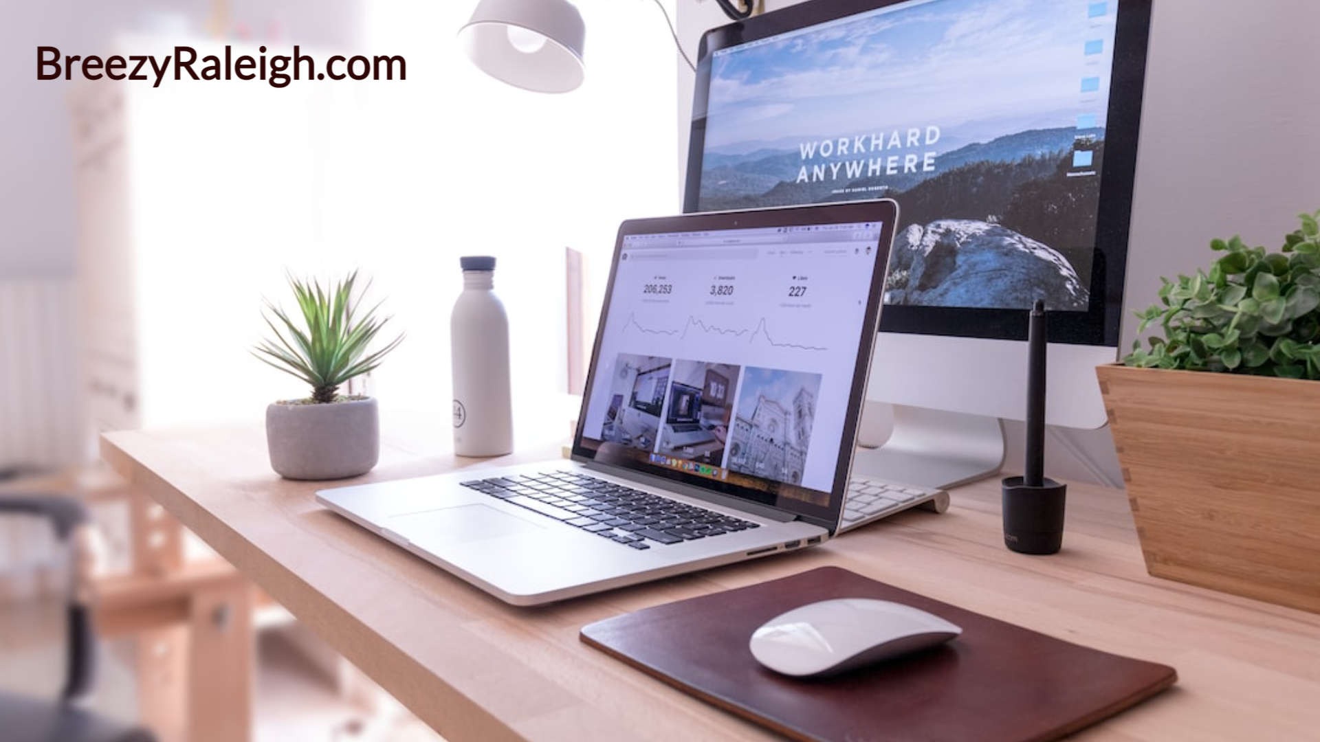 natural wood desk top with two monitors