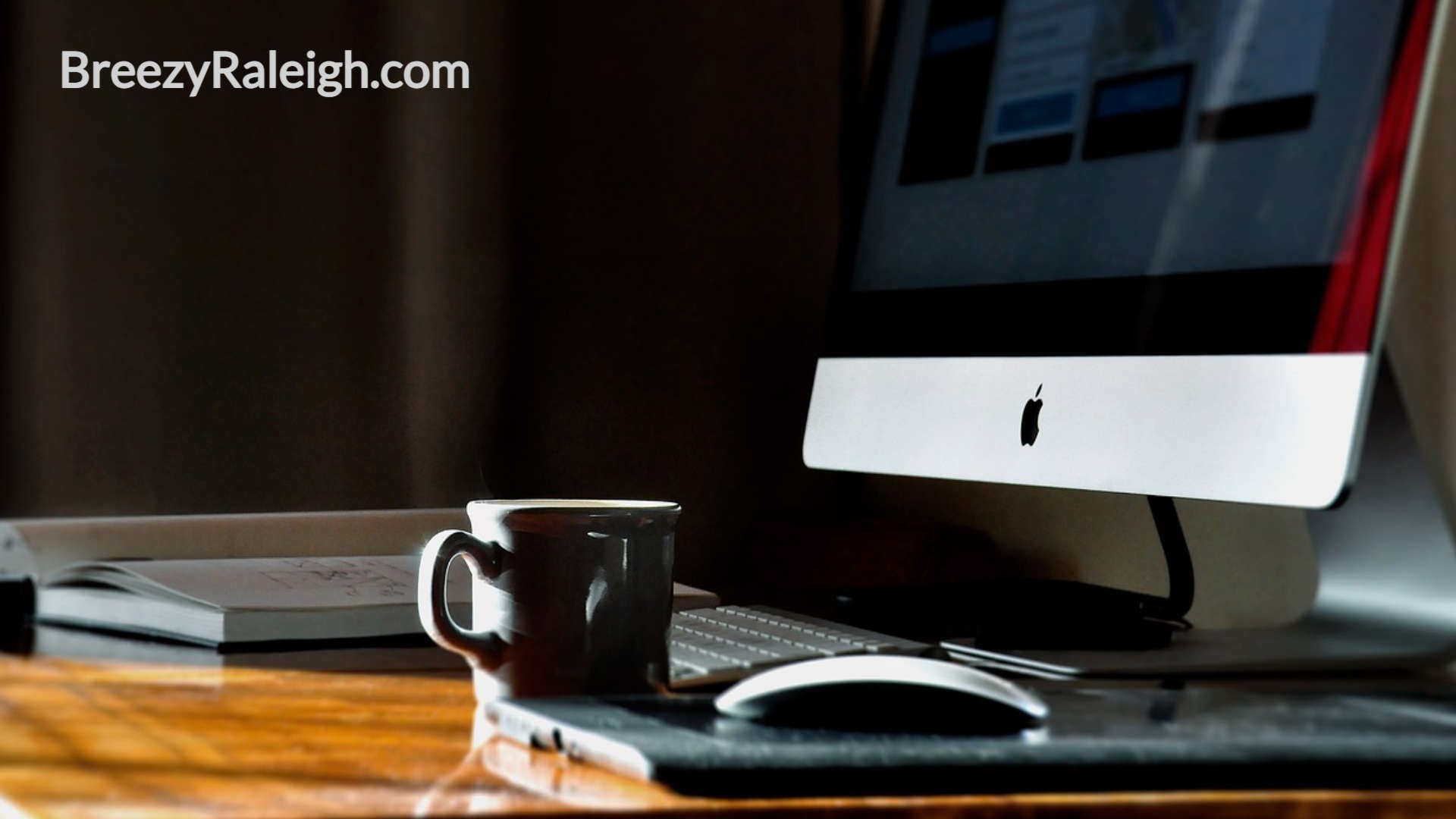 apple computer and coffee cup on desk top