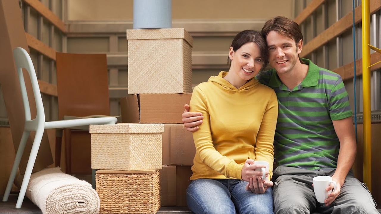 young couple sitting about to move