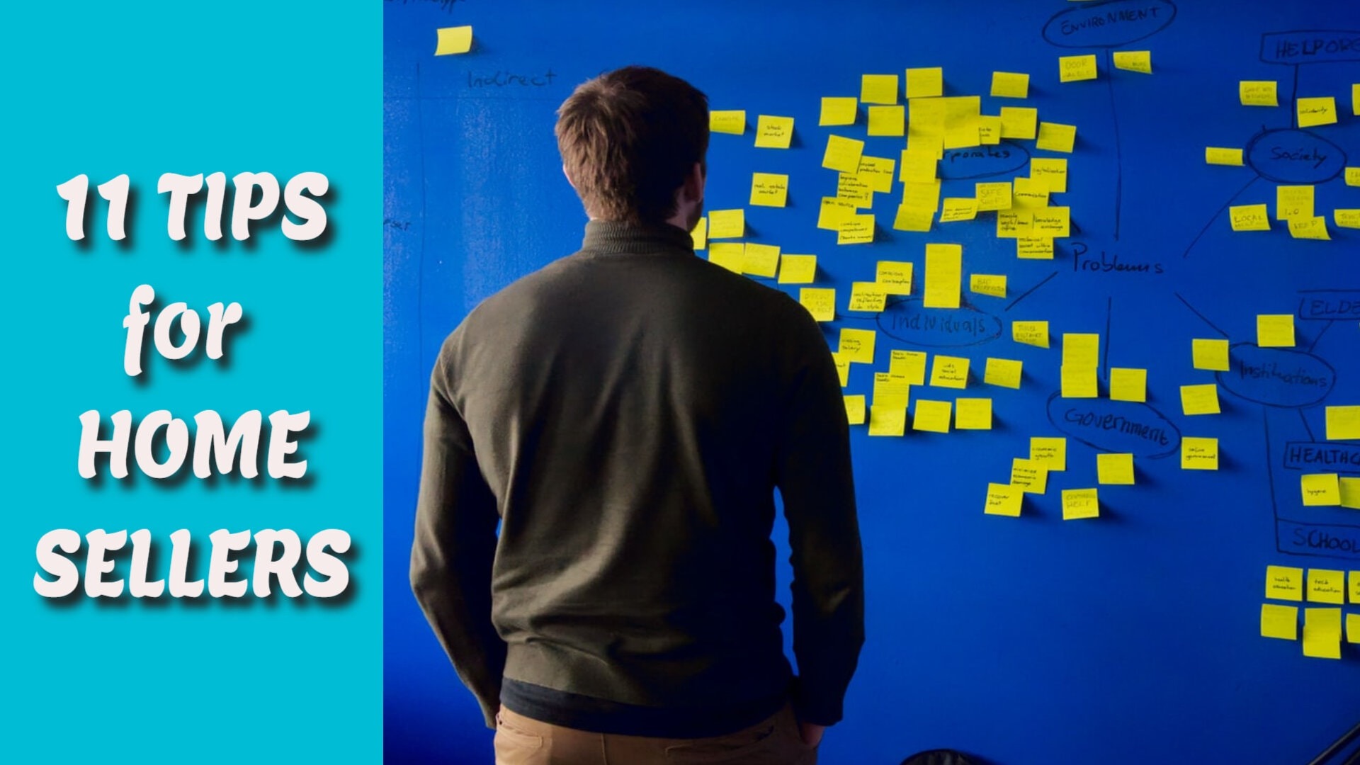 manlooking at blue wall with yellow sticky notes looking at paper