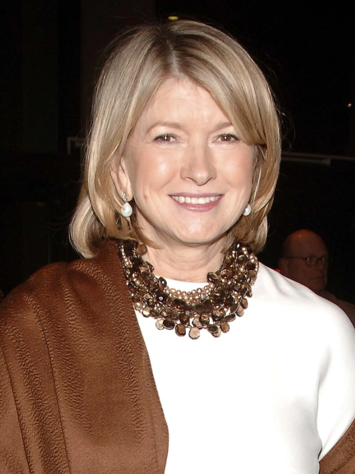 Elegant woman smiling gently at an art event.