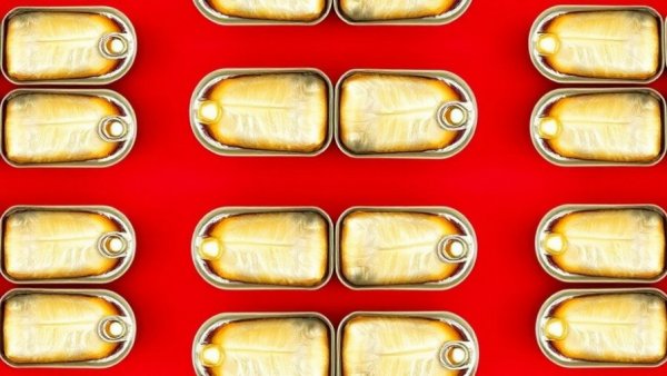 Sardinemaxxing: open sardine cans on a red background