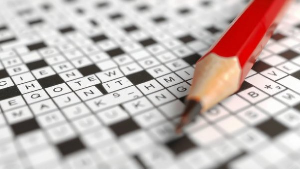 Crossword puzzles and brain health concept with puzzle and pencil.