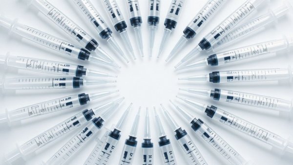 Syringes forming a circular pattern representing health and wellness in Vancouver.