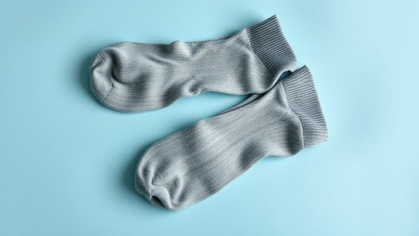 Old gray socks and shoes on a blue surface for DIY craft