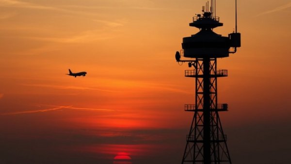 Newark Airport radar upgrade depicted with a control tower and plane at sunset.