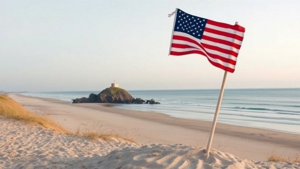 American flag on Omaha Beach during a tranquil sunset.