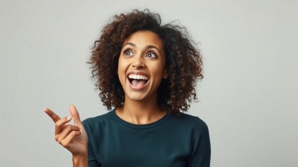 Surprised woman with curly hair reacting energetically.