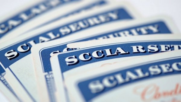 Close-up of Social Security cards highlighting 2026 payment schedule.
