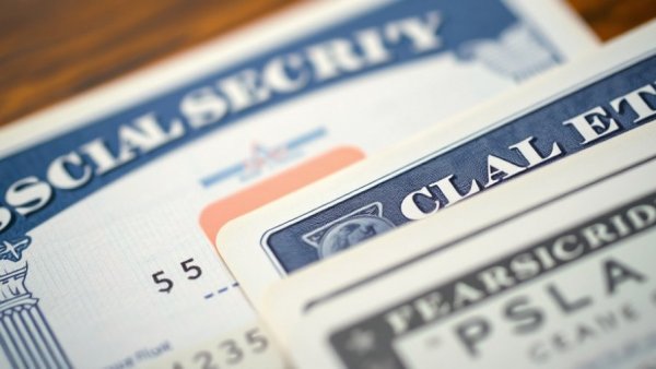 Close-up of Social Security card and US Treasury check, financial focus.
