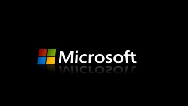 Reflective Microsoft logo on black background, symbolizing brand prominence.