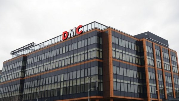 DMC hospital building under overcast sky related to Michigan flu restrictions.