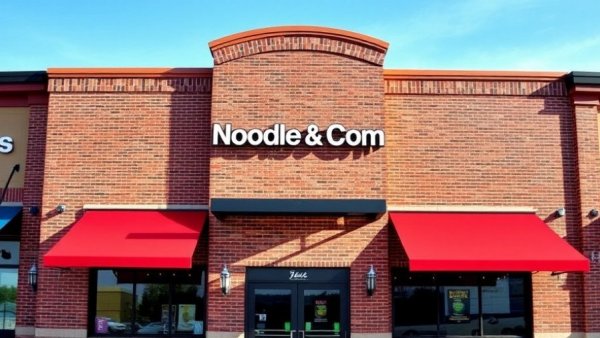Noodles & Company restaurant with red awning and glass doors in Michigan.